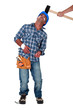 Builder being hit over the head by hammer