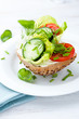 Healthy sandwich with fresh vegetables and herbs