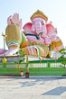 Pink ganesha statue in relaxing action Pink ganesha statue in relaxing action