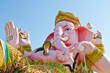 Pink ganesha statue in relaxing action Pink ganesha statue in relaxing action