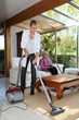Woman vacuuming in senior woman's house