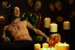 Male vampire sitting on leather chair Male vampire sitting on leather chair