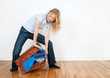 Young woman packing a suitcase Young woman packing a suitcase