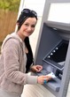 Beautiful woman using ATM