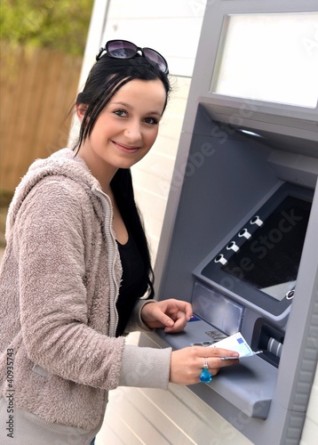 Photo: Beautiful woman using ATM Beautiful woman using ATM