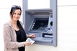Beautiful woman using ATM