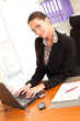 Business woman sitting in the office in front of the laptop