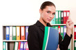 Business woman in front of shelves with folders