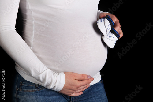 Photo: Pregnant with shoes on his stomach. Pregnant with shoes on his stomach.