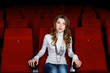 Young girl in cinema watching movie Young girl in cinema watching movie