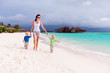 Mother and two boys walking on tropical beach