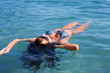 girl lies on sea surface
