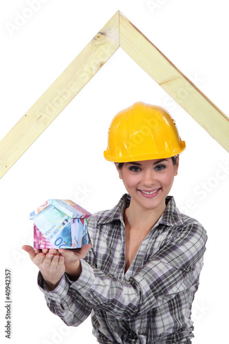 Photo: Builder with a house made of money Builder with a house made of money