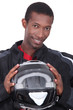 man in a racing suit holding a helmet man in a racing suit holding a helmet