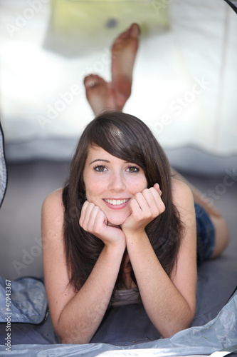Photo: Girl lying in tent Girl lying in tent