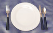 Tableware on blue napkin