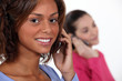 Young women talking on their mobile phones