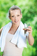 Woman drinking water after exercise Woman drinking water after exercise