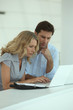 Couple at work on laptops