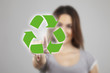 Young woman pressing  recycle icons over white background