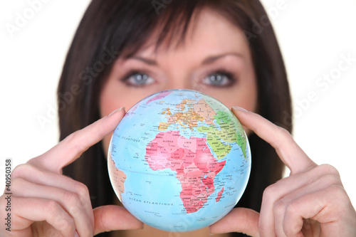 Photo: Woman showing a globe Woman showing a globe
