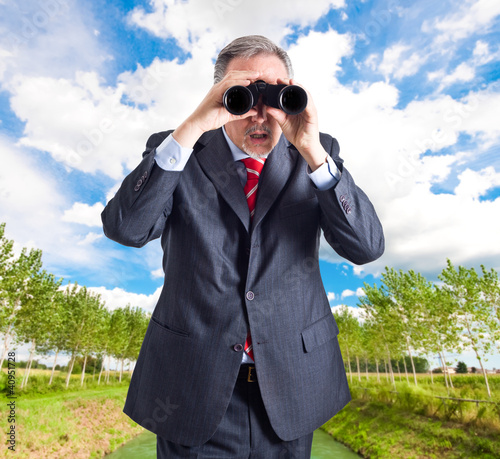 Photo: Businessman using binoculars Businessman using binoculars
