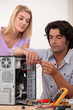 Man repairing PC for colleague