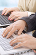 Photo: Hands of business people on notebook keyboard Hands of business people on notebook keyboard