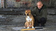 Criminal posing with bat and pit bull in front of graffiti