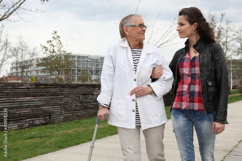 Photo: Woman strolling with an elderly lady Woman strolling with an elderly lady
