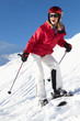Woman On Ski Holiday In Mountains