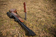 Rifle and knife on a grass