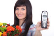 Female florist holding mobile telephone