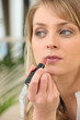Young woman making up
