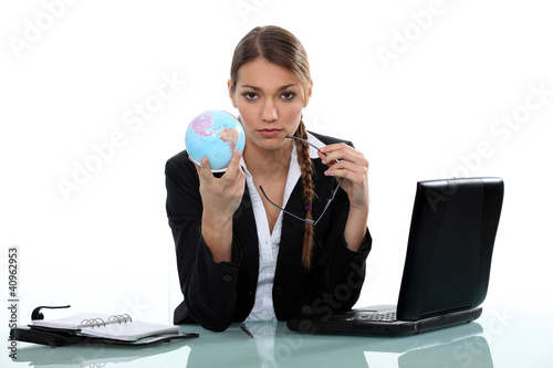 Photo: businesswoman holding a globe businesswoman holding a globe