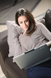 Young Woman on Couch with Laptop