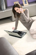 Smiling woman with mobile phone and laptop