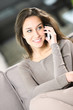 young attractive woman talking on the telephone at home