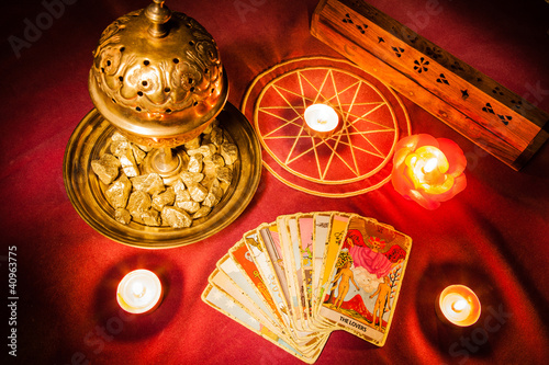 Photo: Tarot cards illuminated by candlelight. Tarot cards illuminated by candlelight.