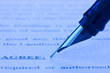 fountain pen and printed agreement
