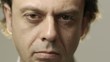 Portrait of serious caucasian adult man looking at camera