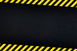 Dark background with yellow caution stripes