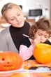 Little girl carving out pumpkin for Halloween Little girl carving out pumpkin for Halloween