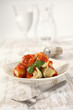 plate on wooden table of ravioli