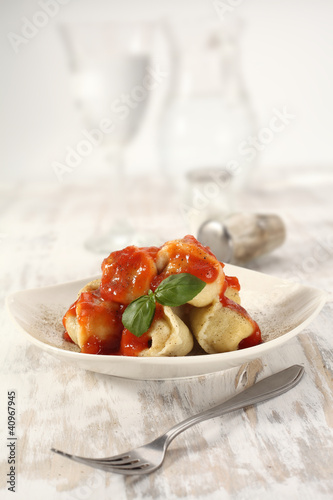 Photo: plate on wooden table of ravioli plate on wooden table of ravioli