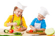 Two smiling kids mixing salad