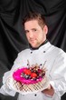Handsome confectioner with cake
