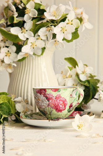 Photo: Tea cup with fresh flower blossoms Tea cup with fresh flower blossoms