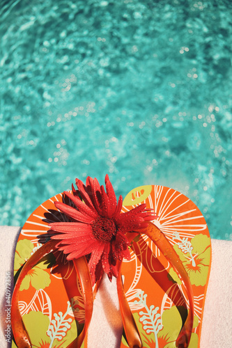 Photo: Flip Flops on white towel pool Flip Flops on white towel pool