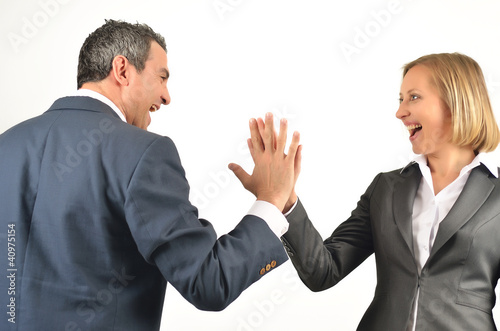 Photo: Young business colleagues giving each other a high five isolated Young business colleagues giving each other a high five isolated